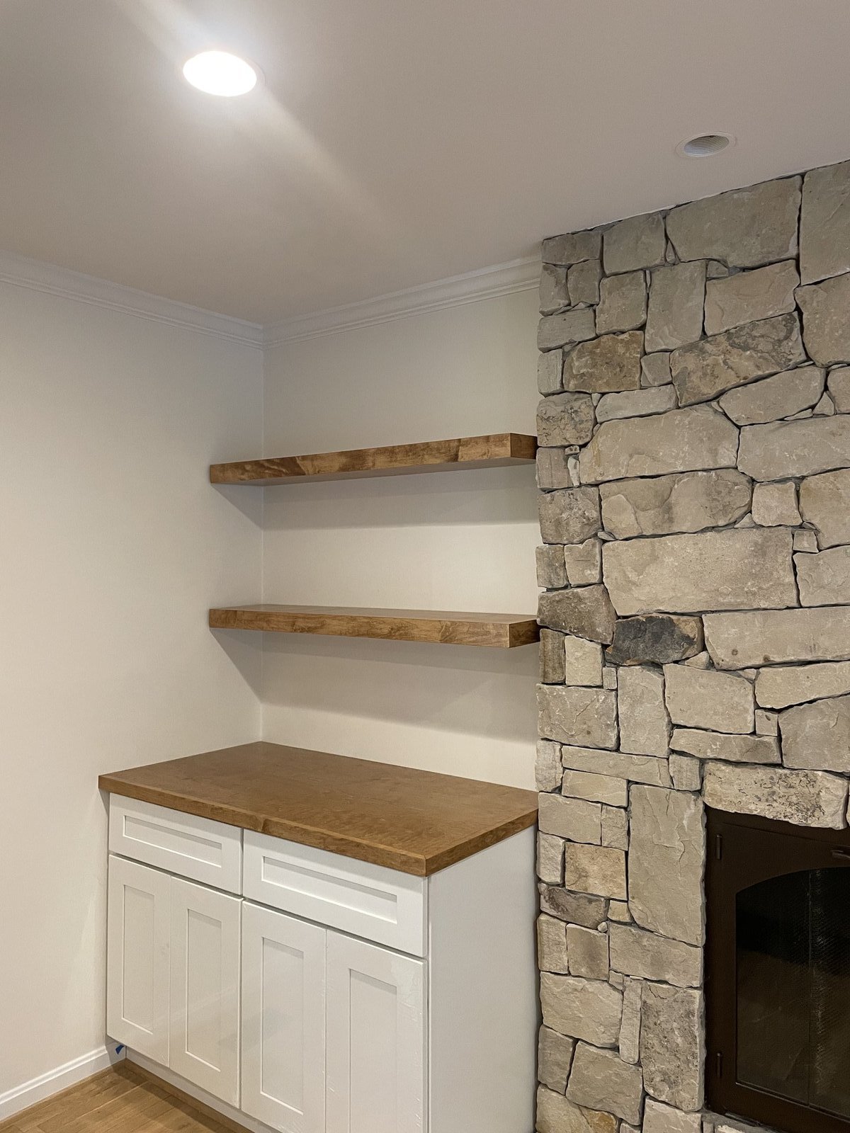 Modern living room with white trim and stone fireplace